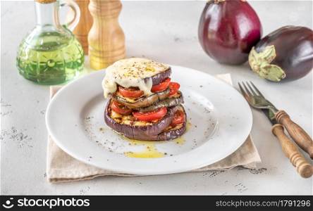 Sliced eggplant with cherry tomatoes and melted mozzarella