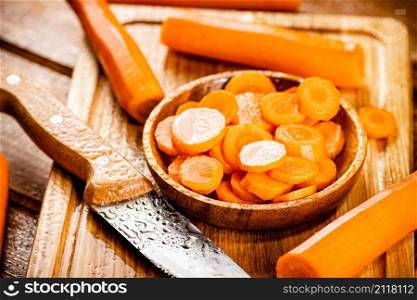 Sliced fresh carrots. On a wooden background. High quality photo. Sliced fresh carrots. On a wooden background.