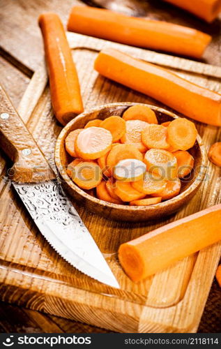 Sliced fresh carrots. On a wooden background. High quality photo. Sliced fresh carrots. On a wooden background.