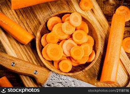 Sliced fresh carrots. On a wooden background. High quality photo. Sliced fresh carrots. On a wooden background.