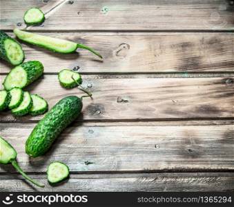 Sliced fresh cucumbers. On wooden background. Sliced fresh cucumbers.