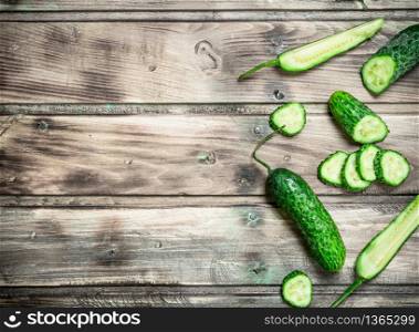 Sliced fresh cucumbers. On wooden background. Sliced fresh cucumbers.