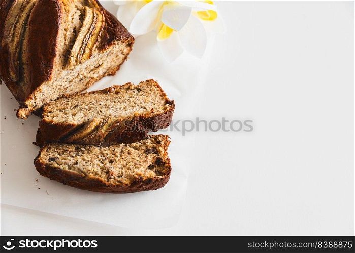 Sliced fresh homemade banana bread on white table. Top view