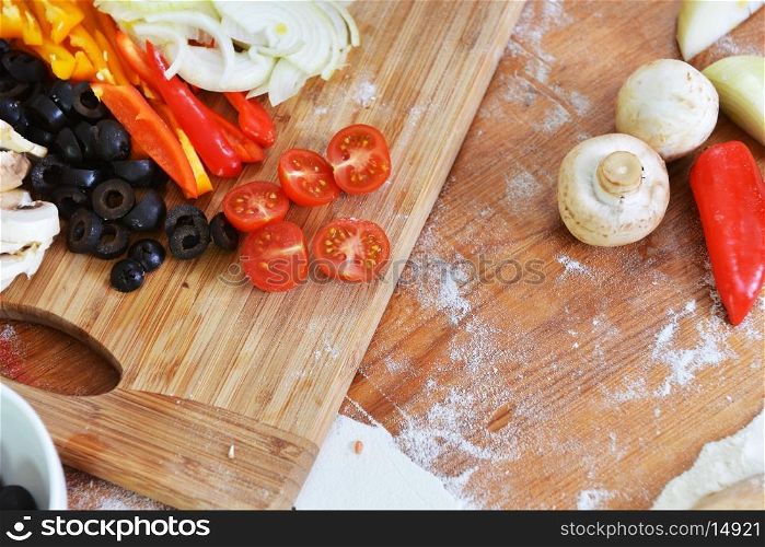 sliced ?? fresh vegetables on wooden background