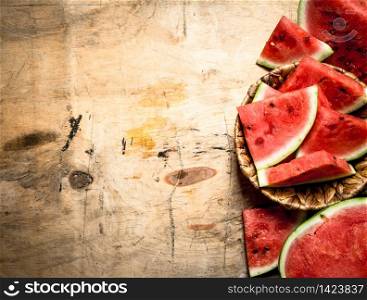 Sliced fresh watermelon. On a wooden background.. Sliced fresh watermelon.