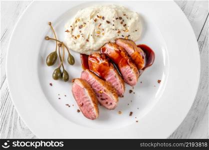 Sliced fried duck breast with red wine sauce