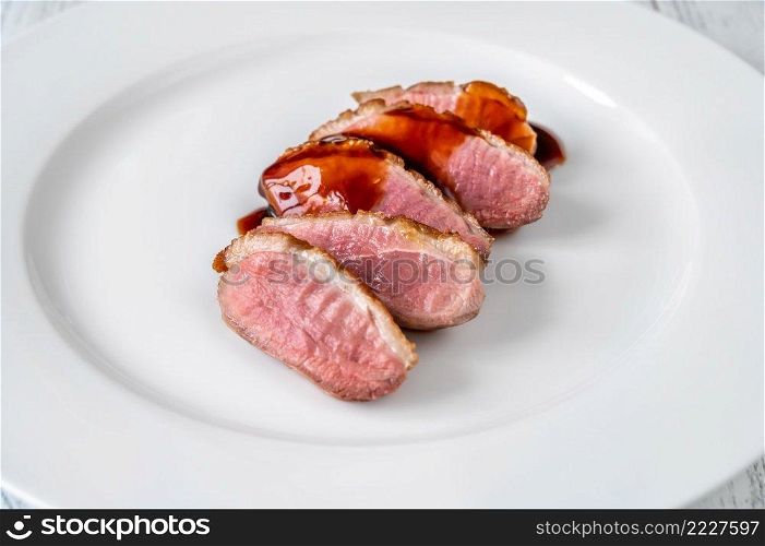 Sliced fried duck breast with red wine sauce