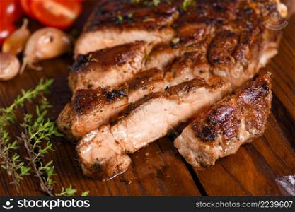 Sliced fried pork steak on a wooden board for serving