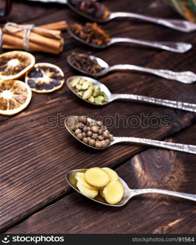 sliced ginger in an iron spoon and other spices