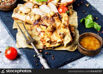 Sliced grilled pork barbecue. Piece of baked meat with mushrooms and spices.Delicious meat.Grilled meat