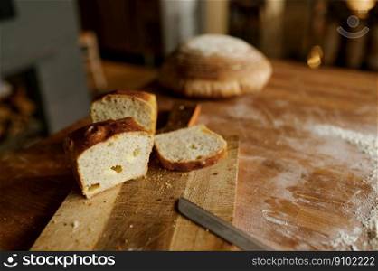 Sliced healthy wheat bread loaf on kitchen wooden board selective focus. Bakery shop concept. Sliced healthy wheat bread loaf on kitchen wooden board