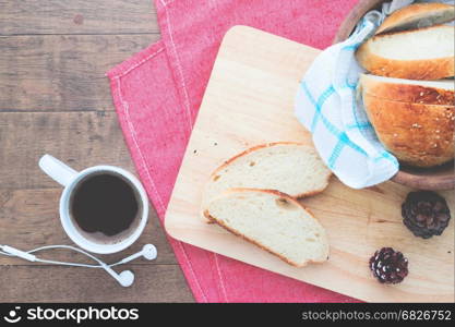 Sliced homemade bread with coffee on wood table with copy space, Healthy lifestyle concept, Flat lay