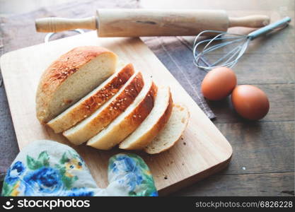 Sliced homemade bread with sesame on wood table