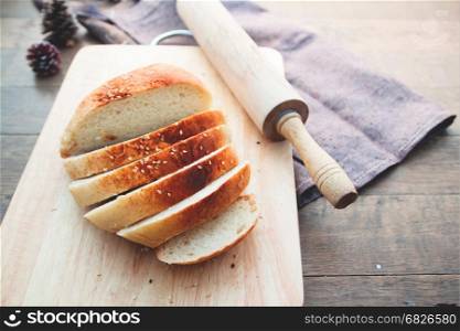 Sliced homemade bread with sesame on wood table