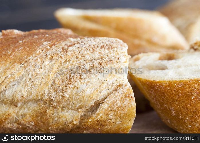sliced long wheat baguette, close-up of food on the kitchen table. sliced long wheat baguette