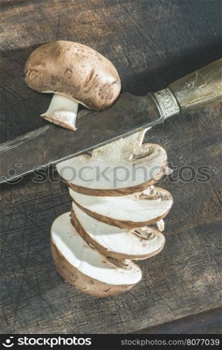 Sliced mushrooms on wooden table