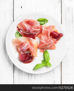 Sliced of Spanish jamon. Traditional Spanish jamon on a bright light background