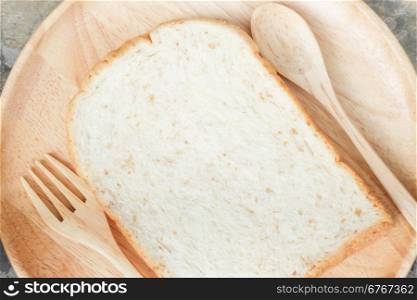 Sliced of whole wheat bread on wooden plate, stock photo
