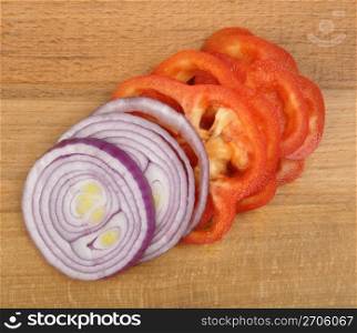 sliced onion and pepper on a wooden board