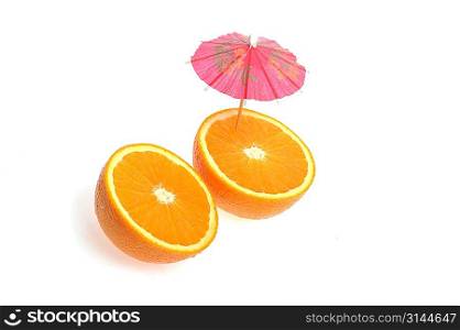 sliced orange with coctail umbrella on white