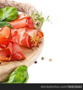 Sliced prosciutto with salami,cheese and basil on a wooden board