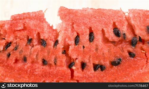 sliced red juicy watermelon with black seeds, close-up of a very tasty berry ripening in late summer or early autumn. sliced red juicy watermelon