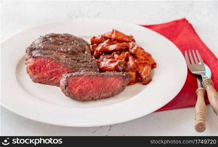 Sliced rib eye steak with mushroom stew