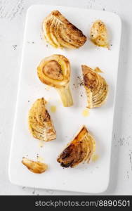 Sliced roasted fennel on the white plate