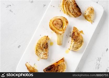 Sliced roasted fennel on the white plate