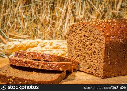 sliced rye bread close-up on a background of hay