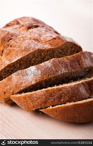 Sliced rye bread on wooden table