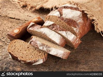 Sliced rye bread with a knife on the table