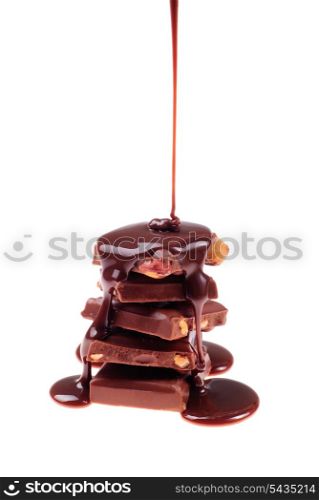 Sliced shocolate with nuts isolated on white and melting syrup