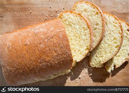 sliced sicilian semolina yellow bread on wooden board