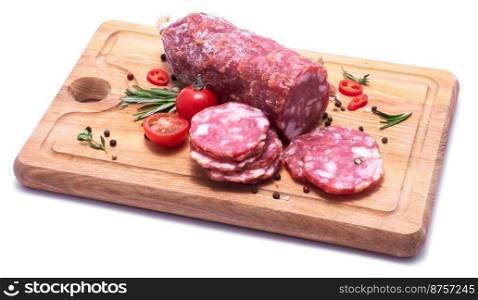 Sliced Smoked dry Salami sausage on wooden cutting board isolated on white background.. Sliced Smoked dry Salami sausage on wooden cutting board isolated on white background