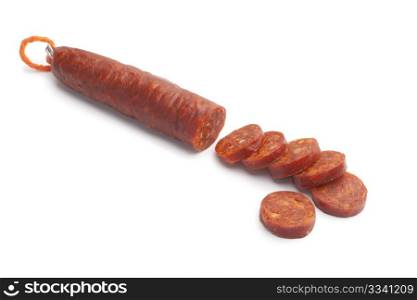 Sliced Spanish chorizo sausage on white background