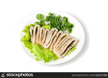 sliced squid and green vegetables dish isolated on white