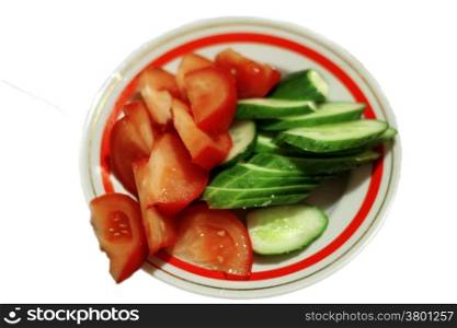 Sliced tomato and cucumber on the plate isolated