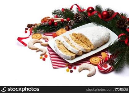 Sliced Traditional Christmas stollen cake with marzipan and dried fruit isolated on ceramic plate. High quality photo. Sliced Traditional Christmas stollen cake with marzipan and dried fruit isolated on ceramic plate