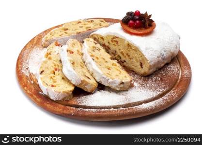 Sliced Traditional Christmas stollen cake with marzipan and dried fruit isolated on white background. High quality photo. Sliced Traditional Christmas stollen cake with marzipan and dried fruit isolated on white background