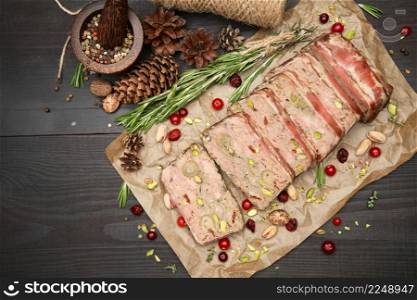 Sliced Traditional French terrine covered with bacon on dark wooden background. High quality photo. Sliced Traditional French terrine covered with bacon on dark wooden background