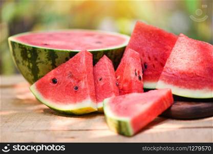 Sliced watermelon on wooden and nature background / Close up fresh watermelon pieces tropical summer fruit