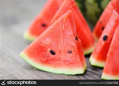 Sliced watermelon on wooden background / Close up fresh watermelon pieces tropical summer fruit