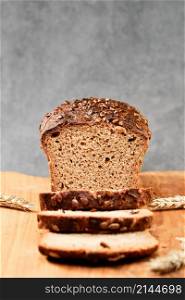 Sliced wheat rye bread on a cutting board. Whole grain bread with seeds. Naturally fermented homemade healthy bread