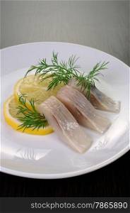 slices delicates of herring with lemon dill
