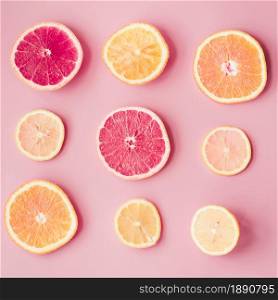 slices fresh citrus fruits pink background. Resolution and high quality beautiful photo. slices fresh citrus fruits pink background. High quality and resolution beautiful photo concept