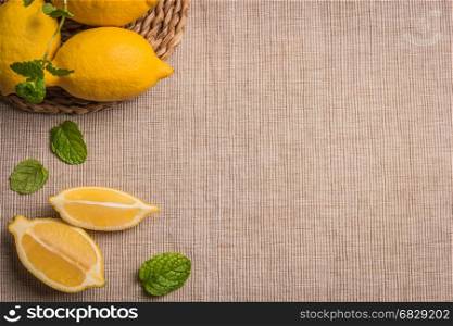 Slices, half fresh juicy lemon with mint leaves. Top view with copy space.