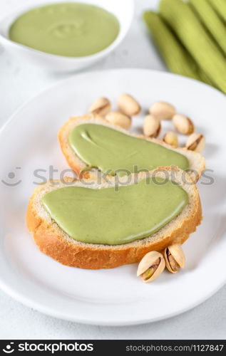 Slices of baguette with pistachio butter