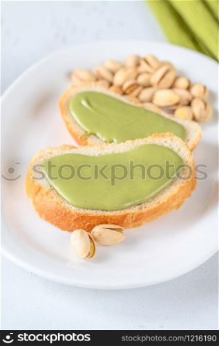 Slices of baguette with pistachio butter