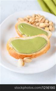 Slices of baguette with pistachio butter